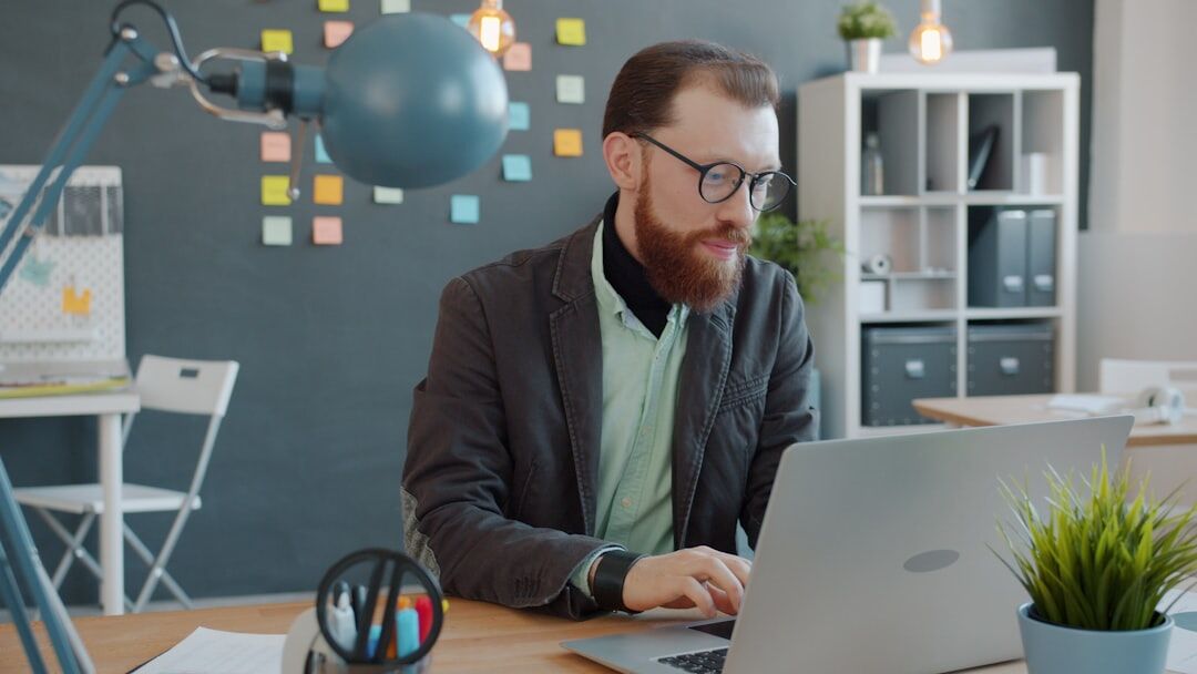 Journalist working at a laptop in a modern office